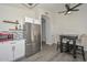 Kitchen with stainless steel refrigerator and microwave, floating shelves, and modern dining area at 11224 W Puget Ave, Peoria, AZ 85345