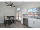 Eat-in kitchen area featuring a dark table and chairs, stainless steel appliances, and white cabinets at 11224 W Puget Ave, Peoria, AZ 85345