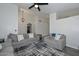 Comfortable living room with gray couches, stylish lighting, and a smooth flow to the kitchen area at 11224 W Puget Ave, Peoria, AZ 85345