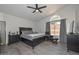 Vaulted ceiling in primary bedroom with ample natural light, dark furniture, and gray flooring at 11224 W Puget Ave, Peoria, AZ 85345