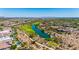 Panoramic aerial of lush golf course, serene lake, and luxury homes, nestled in a desert environment at 11796 W Creosote Dr, Peoria, AZ 85383
