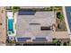 Aerial view of home featuring a tile roof, solar panels, pool, spa, and landscaping at 11796 W Creosote Dr, Peoria, AZ 85383