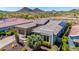 Single-story home featuring desert landscaping, a tile roof, a three car garage, and solar panels at 11796 W Creosote Dr, Peoria, AZ 85383