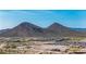 Wide aerial view showing new home construction within a planned community against a mountain backdrop at 11796 W Creosote Dr, Peoria, AZ 85383