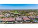 Expansive aerial view highlighting community homes, golf course, and lake in a desert setting at 11796 W Creosote Dr, Peoria, AZ 85383