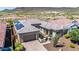 Single-story home with a tile roof, desert landscaping, brick driveway and solar panels at 11796 W Creosote Dr, Peoria, AZ 85383