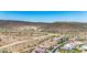 Overhead view of homes with pools nestled into the desert landscape with the mountain range in the distance at 11796 W Creosote Dr, Peoria, AZ 85383
