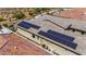 Solar panels on tile roof for energy efficiency, surrounded by desert landscape and neighboring homes at 11796 W Creosote Dr, Peoria, AZ 85383