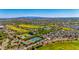 Expansive aerial showcases community amenities: a pool, tennis courts, and golf course with desert mountain views at 11796 W Creosote Dr, Peoria, AZ 85383