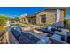 Inviting backyard with a cozy seating area around a modern fire pit, swimming pool and attached spa at 11796 W Creosote Dr, Peoria, AZ 85383