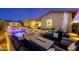 Outdoor entertaining area featuring a pool, hot tub, fire pit, and lounge chairs at twilight at 11796 W Creosote Dr, Peoria, AZ 85383