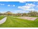 Outdoor basketball court area surrounded by lush greenery and a walking path at 11796 W Creosote Dr, Peoria, AZ 85383