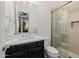 Modern bathroom featuring a glass shower, dark wood cabinets, and a white quartz countertop at 11796 W Creosote Dr, Peoria, AZ 85383