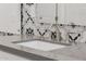 A modern bathroom sink with brushed nickel fixtures and decorative backsplash at 11796 W Creosote Dr, Peoria, AZ 85383