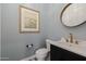A stylish powder room with decorative tile flooring and unique artwork at 11796 W Creosote Dr, Peoria, AZ 85383
