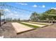 Bocce ball courts, perfect for friendly competition, enhanced with cafe lights and lush green landscaping at 11796 W Creosote Dr, Peoria, AZ 85383