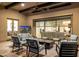 Inviting covered patio with comfortable seating, a fireplace, and access to the indoors at 11796 W Creosote Dr, Peoria, AZ 85383