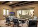 Inviting covered patio with comfortable seating, a fireplace, and access to the indoors at 11796 W Creosote Dr, Peoria, AZ 85383