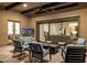 Inviting covered patio with comfortable seating, a fireplace, and access to the indoors at 11796 W Creosote Dr, Peoria, AZ 85383