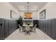Formal dining room with modern decor, stylish lighting fixture, and wainscoting at 11796 W Creosote Dr, Peoria, AZ 85383