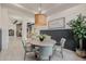 Chic dining area with a modern light fixture, round table, and stylish chairs at 11796 W Creosote Dr, Peoria, AZ 85383