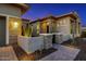 Modern home entrance with a stone facade, desert landscaping, and a paved walkway at 11796 W Creosote Dr, Peoria, AZ 85383