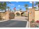 Elegant community entrance with stone pillars, iron gates, and lush landscaping, showcasing exclusivity and secure access at 11796 W Creosote Dr, Peoria, AZ 85383