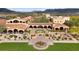 Aerial view of the beautiful estate showing the stunning architecture, a fountain, and mature landscaping at 11796 W Creosote Dr, Peoria, AZ 85383