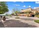 Exterior of a multi-story building with manicured landscaping and a covered patio at 11796 W Creosote Dr, Peoria, AZ 85383