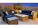 Cozy outdoor living space featuring a stylish fire pit, comfortable seating, and evening ambiance at 11796 W Creosote Dr, Peoria, AZ 85383
