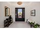 Bright foyer showcasing a black front door, patterned rug, and decorative accents, creating a welcoming entrance at 11796 W Creosote Dr, Peoria, AZ 85383