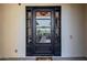 Contemporary front door featuring glass panels, stucco surround, and brick paver walkway at 11796 W Creosote Dr, Peoria, AZ 85383