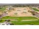 Aerial view of a well-manicured golf course, highlighting its expansive fairways, greens, and natural desert surroundings at 11796 W Creosote Dr, Peoria, AZ 85383