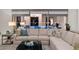 Comfortable living area with a large sectional couch, soft pillows, and ambient lighting at 11796 W Creosote Dr, Peoria, AZ 85383