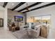 Bright living room with exposed beam ceiling, wood accent wall, and mountain views at 11796 W Creosote Dr, Peoria, AZ 85383