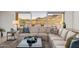 Bright living room featuring a large sectional couch, mountain views, and a neutral color palette at 11796 W Creosote Dr, Peoria, AZ 85383