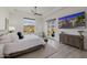 Tranquil main bedroom featuring mountain views, hardwood floors, a ceiling fan, and a neutral color scheme at 11796 W Creosote Dr, Peoria, AZ 85383