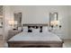 Elegant main bedroom with decorative mirrors and stylish bedside tables at 11796 W Creosote Dr, Peoria, AZ 85383