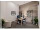 Bright office space with a wood accent wall, stylish furnishings, and ample natural light at 11796 W Creosote Dr, Peoria, AZ 85383