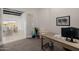 Office area with a view to the living room, showing ample light, neutral tones, and tasteful artwork at 11796 W Creosote Dr, Peoria, AZ 85383