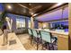 Custom outdoor bar featuring built-in beer taps and comfortable seating with a ceiling fan at 11796 W Creosote Dr, Peoria, AZ 85383