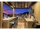 Outdoor kitchen with built-in grill, bar seating, fan, and a TV, perfect for entertaining at 11796 W Creosote Dr, Peoria, AZ 85383