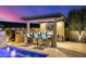 Outdoor kitchen and barbecue area with countertop seating, grill, and built-in bar at 11796 W Creosote Dr, Peoria, AZ 85383