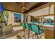 Outdoor kitchen with bar seating, beer tap and mountain views; perfect for entertaining guests at 11796 W Creosote Dr, Peoria, AZ 85383