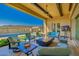 Inviting outdoor living area with a fire pit and comfortable seating, overlooking the pool and beautiful scenery at 11796 W Creosote Dr, Peoria, AZ 85383