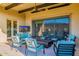 Outdoor patio with comfortable seating, a ceiling fan, tv and mountain views at 11796 W Creosote Dr, Peoria, AZ 85383