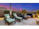 Enjoy the evening on this cozy outdoor patio with comfortable seating and a warm fire pit under the stars at 11796 W Creosote Dr, Peoria, AZ 85383