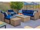 Inviting patio with a fire pit, comfortable seating, and desert views for relaxing or entertaining at 11796 W Creosote Dr, Peoria, AZ 85383