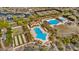 Aerial view of the community pool featuring ample seating, lush landscaping, and a covered lounge area at 11796 W Creosote Dr, Peoria, AZ 85383