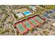 Aerial view showcases four well-maintained tennis courts with players, plus a pool, and playground in the community at 11796 W Creosote Dr, Peoria, AZ 85383